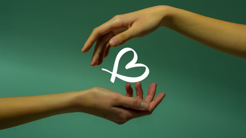A hand passing on the BALANCE B logo to another hand