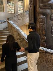 walking past a totem pole at the Royal Ontario Museum